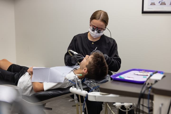 Hygienist cleaning a patient's teeth