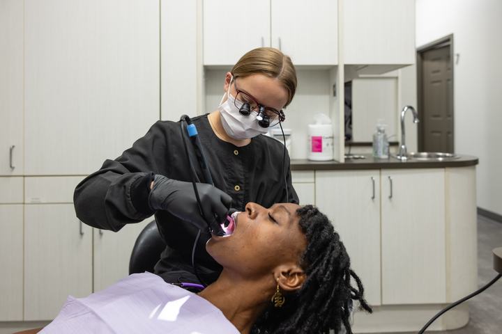 Hygienist cleaning a patient's teeth