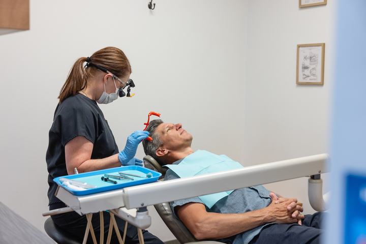 Hygienist cleaning a patient's teeth