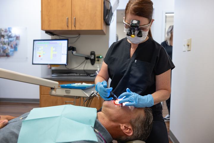 Hygienist cleaning a patient's teeth