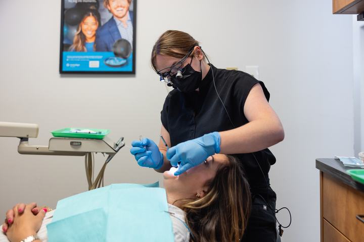 Hygienist cleaning a patient's teeth