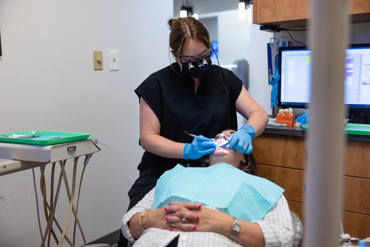 Hygienist cleaning a patient's teeth