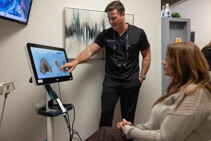 Doctor showing a patient an Invisalign smile preview