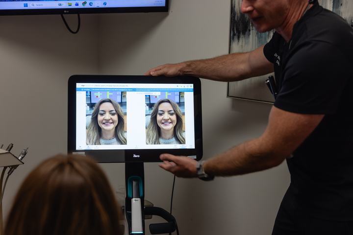Doctor showing a patient an Invisalign smile preview