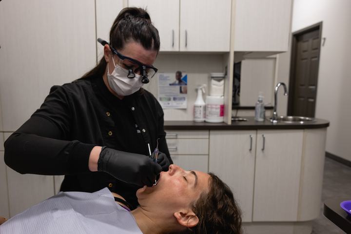 Hygienist cleaning a patient's teeth