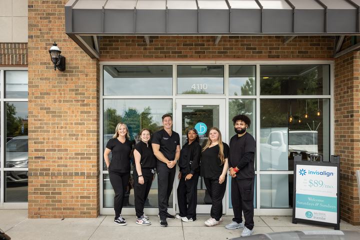 Team members by the office entrance